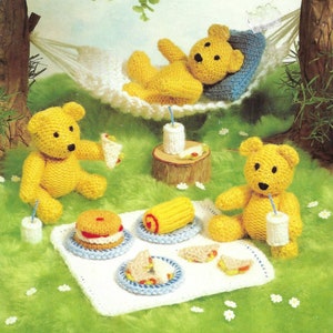 May include: A knitting pattern booklet featuring a collection of knitted toy designs. The cover shows three yellow teddy bears, one in a hammock, one holding a sandwich, and one drinking from a glass. The booklet is titled "Jean Greenhowe's Toy Collection" and includes the text "Over twenty easy-to-knit designs".