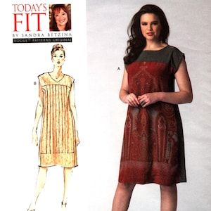 May include: A sewing pattern for a dress with two different styles. The first style is a simple, sleeveless dress with a V-neck and a straight skirt. The second style is a more elaborate dress with a paisley print and a contrasting gray yoke. The pattern is from Vogue Patterns and is designed by Sandra Betzina.
