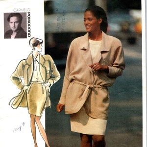 May include: A vintage sewing pattern for a beige jacket and skirt. The pattern is from Vogue Attitudes and is size 8-10-12. The pattern is for a jacket with a tie belt and a skirt with a zipper.