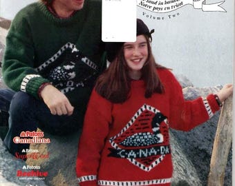 May include: A knitting pattern book titled Patons O Canada! Our land in handknits Volume Two, featuring a dark green sweater with a white loon graphic and a red sweater with a matching white loon graphic and the text CANADA on the front.