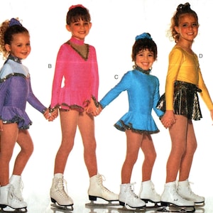 May include: Four girls wearing figure skating costumes. The girl on the left is wearing a purple costume with silver trim. The girl in the middle is wearing a pink costume with silver trim. The girl on the right is wearing a blue costume with silver trim. The girl in the back is wearing a yellow costume with a silver skirt.