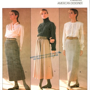 May include: Vogue Patterns American Designer sewing pattern for a skirt. The pattern includes three different skirt styles: a plaid skirt, a calf-length skirt, and a long skirt. The pattern is by Calvin Klein and is number 1790.