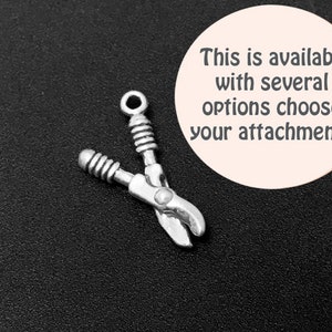 May include: Silver charm in the shape of a pair of pruning shears. The charm is a popular choice for jewelry making and crafting projects.