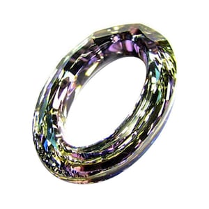 May include: A clear iridescent crystal ring with a faceted oval shape.