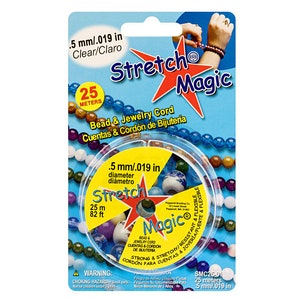 May include: Clear Stretch Magic bead and jewellery cord on a blue and white card. The cord is .5 mm diameter and 25 metres long. The packaging features the text "Stretch Magic" and a starburst design.