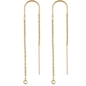May include: A pair of gold-toned earrings with a curved wire and a dangling chain. The chain has a small loop at the end.