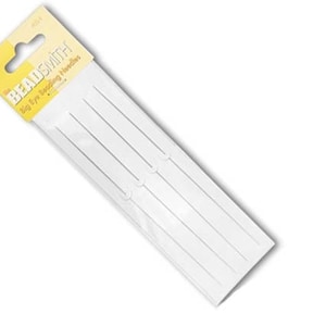 May include: A package of white beading needles, labeled "Beadsmith Big Eye Beading Needles".