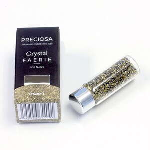 May include: A small glass bottle filled with gold and black glitter, labeled "PRECiosa Bohemian crafted since 1948 Crystal FAERIE for NAILS 24KARATS".