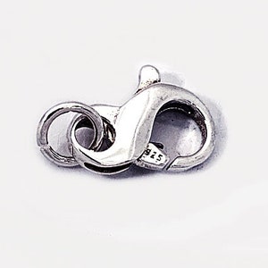 May include: Silver-toned lobster clasp with a spring ring closure. The clasp is marked with "925" indicating sterling silver.