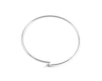 May include: A silver hoop earring with a small ball at the end.