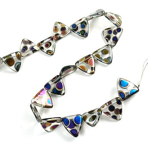 May include: A strand of clear glass triangle beads with iridescent multi-colored circles inside. The beads are strung on a clear thread.