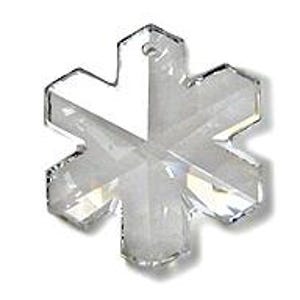Swarovski Magic Classic Crystal snowflake ornament .A silver snowflake pendant necklace with a clear crystal snowflake charm. The necklace has a white satin ribbon.