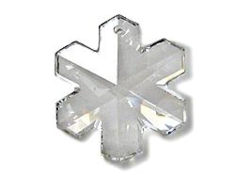 Swarovski Magic Classic Crystal snowflake ornament .A silver snowflake pendant necklace with a clear crystal snowflake charm. The necklace has a white satin ribbon.