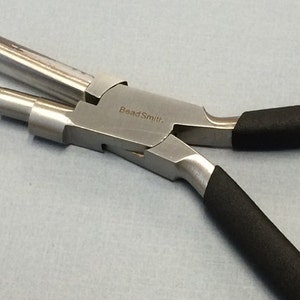 May include: A silver bead-making pliers with black rubber handles. The pliers have a BeadSmith logo on the side. The pliers have multiple different sized holes for making different sized loops.