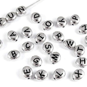 May include: Silver letter beads with black lettering. The letters include A, B, C, D, E, F, G, H, I, J, K, L, M, N, O, P, Q, R, S, T, U, V, W, X, Y, and Z.