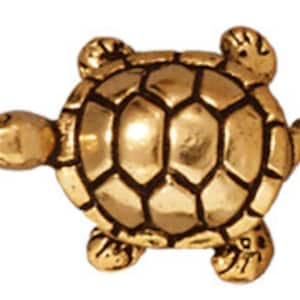 May include: A gold-colored turtle figurine with a detailed shell and a smooth, polished finish.