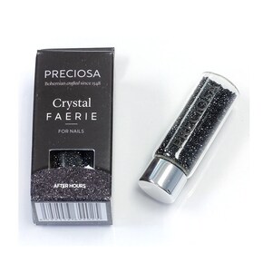 May include: A small glass bottle filled with black glitter. The bottle has a silver cap and a label that reads "Preciosa Bohemian crafted since 1548 Crystal Faerie for Nails After Hours".