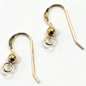 May include: Two gold-toned earring hooks with a small ball at the top and a loop at the bottom.