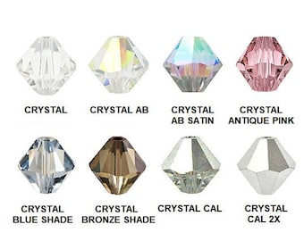 May include: Assortment of eight crystal beads in various colors and finishes, including crystal, crystal AB, crystal AB satin, crystal antique pink, crystal blue shade, crystal bronze shade, crystal cal, and crystal cal 2x.