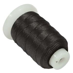 May include: A spool of black waxed thread for sewing leather or other materials.