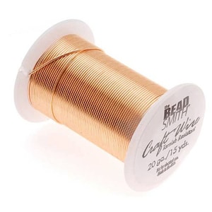 May include: A spool of 20 gauge copper craft wire, 15 yards long, tarnish resistant. The spool is labeled "The Bead Smith Craft Wire 20 ga./15 yds. Tarnish Resistant"