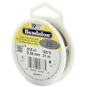 May include: A spool of 19 strand Beadalon bead stringing wire in silver. The spool is labeled with the text "Beadalon", "Bead Stringing Wire", "Fil Pour Enfiler Les Perles", "Alambre Para Joyeria", "Bright", "Brilliant", "Brillante", ".015 in", "0.38 mm", "100 ft", "31 m", "JW14T-1", and a barcode.