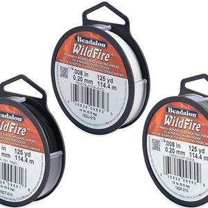 May include: Three spools of Beadalon WildFire thermally bonded bead weaving thread. The spools are labeled with the thread color and size: Frost White, Black, and Green. Each spool is 125 yards (114.4 meters) long and 0.008 inches (0.20 mm) in diameter.