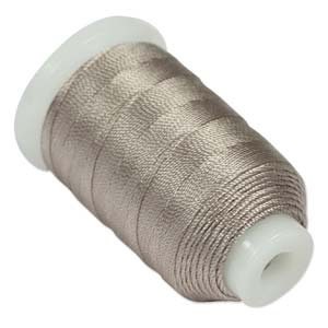 May include: A spool of light brown thread.