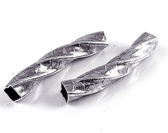 May include: Two silver twisted metal tubes with a textured surface.