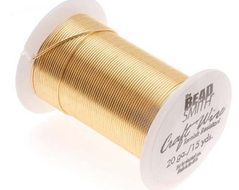 May include: A spool of gold-colored craft wire by The Bead Smith. The white plastic spool features black text reading The Bead Smith Craft Wire, 20 ga./15 yds., and indicates it is tarnish resistant. The wire is tightly wound around the spool.