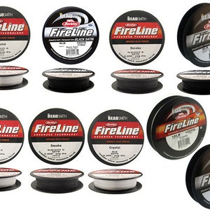 May include: Assortment of Berkley FireLine fishing line spools in various colors and sizes. The spools are labeled with the line type, such as Crystal, Smoke, and Black Satin. The line is available in 10lb and 18lb test.