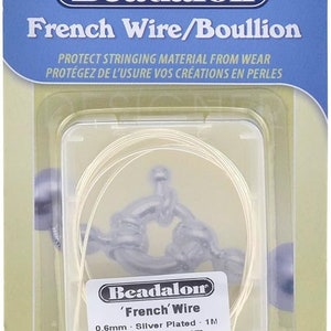 May include: A package of Beadalon French Wire/Bouillon, silver-plated, 0.6mm (.024") in diameter, and 1 meter in length. The package is blue and white, with the product name and details printed on the front. The wire is coiled inside a clear plastic container.