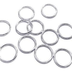 May include: A set of ten silver jump rings, perfect for jewelry making or crafting projects.