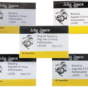 May include: Five packages of John James beading needles. Each package contains 25 needles and is labeled with the size and product information. The packages are black with a yellow border and feature a dragon logo.