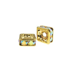 May include: Two gold-toned square bead caps with clear iridescent rhinestones around the edge. The bead caps have a hole in the center for stringing.