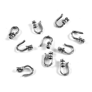 May include: Ten silver-toned metal hooks with a loop at the top and a barrel-shaped connector at the bottom.