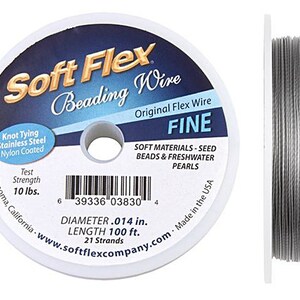 May include: A spool of Soft Flex beading wire, labeled "FINE," with a diameter of .014 inches and a length of 100 feet. The packaging indicates a test strength of 10 lbs. The wire is designed for knot tying and is nylon coated.