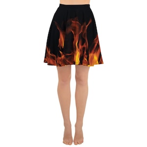 May include: A black skater skirt with a flame pattern in shades of orange and yellow.