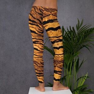 May include: A pair of leggings with a tiger stripe pattern in shades of brown and orange.