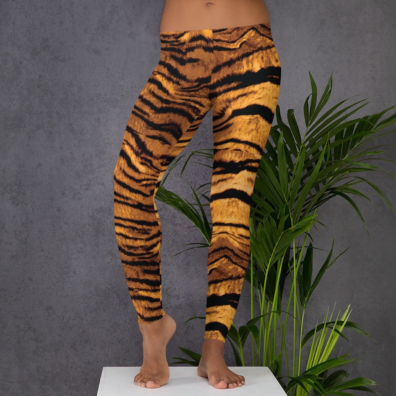 May include: A pair of black leggings with a tiger print pattern in shades of orange and brown.