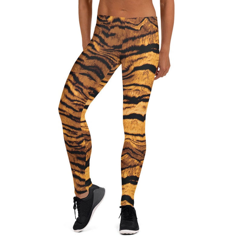 May include: A pair of black leggings with a tiger print pattern. The leggings are made of a stretchy, comfortable fabric and are perfect for yoga, running, or any other workout.