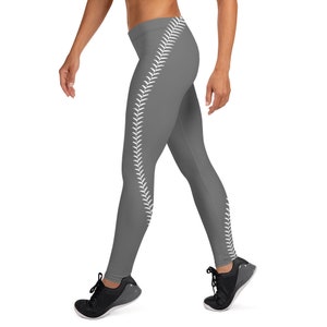 May include: Gray leggings with a white baseball stitch design down the side of one leg.