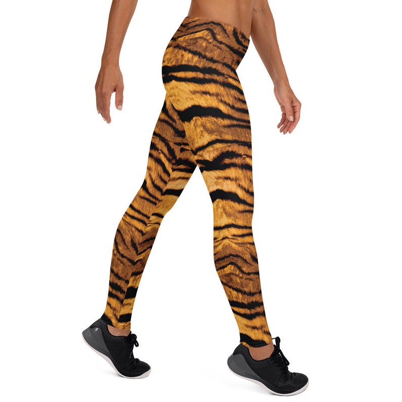 May include: A pair of black leggings with a tiger print pattern. The leggings are made of a stretchy, comfortable fabric and are perfect for working out or running errands.