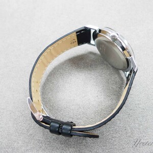 May include: A silver wristwatch with a black leather band. The watch face is not visible in the image.
