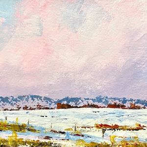 May include: A painting of a snowy landscape with a distant mountain range in the background. The sky is a soft pink and blue, with wispy clouds. The foreground is covered in snow, with a few patches of brown grass and a fence.
