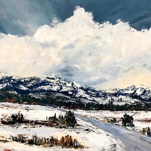 May include: A snowy landscape painting with a winding road leading to a mountain range in the distance. The sky is a deep blue with large, fluffy white clouds.