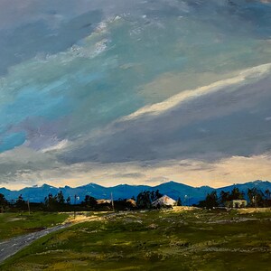 May include: A painting of a landscape with a single-story house in the distance. The sky is a light blue with white clouds. The mountains in the background are a dark blue. The foreground is a field of green grass.
