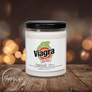 May include: A white candle in a glass jar with a black lid. The label features the word "Viagra" in a stylized font, with a green and orange graphic. The text "The Dicker Picker Upper!" is also on the label, along with "HappyLife Home".