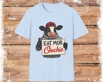 Cow Holding "Eat Mor Coochie" Sign T-Shirt | Humorous Cow Illustration