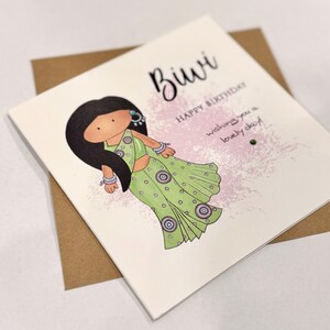 A cute birthday card for a special Biwi (wife) This South Asian lady is dressed to impress in a pastel green sari with matching jewellery. A perfect keepsake card to make her smile. Card front reads, Biwi happy birthday, wishing you a lovely day.